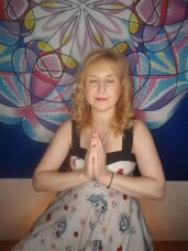 Mgr. Ajasta, vztahová alchymistka, v meditaci s rukama složenýma v gestu vděčnosti před barevnou mandalou — symbol vcítění a návratu k sobě jako prvního kroku ke změně vztahu.